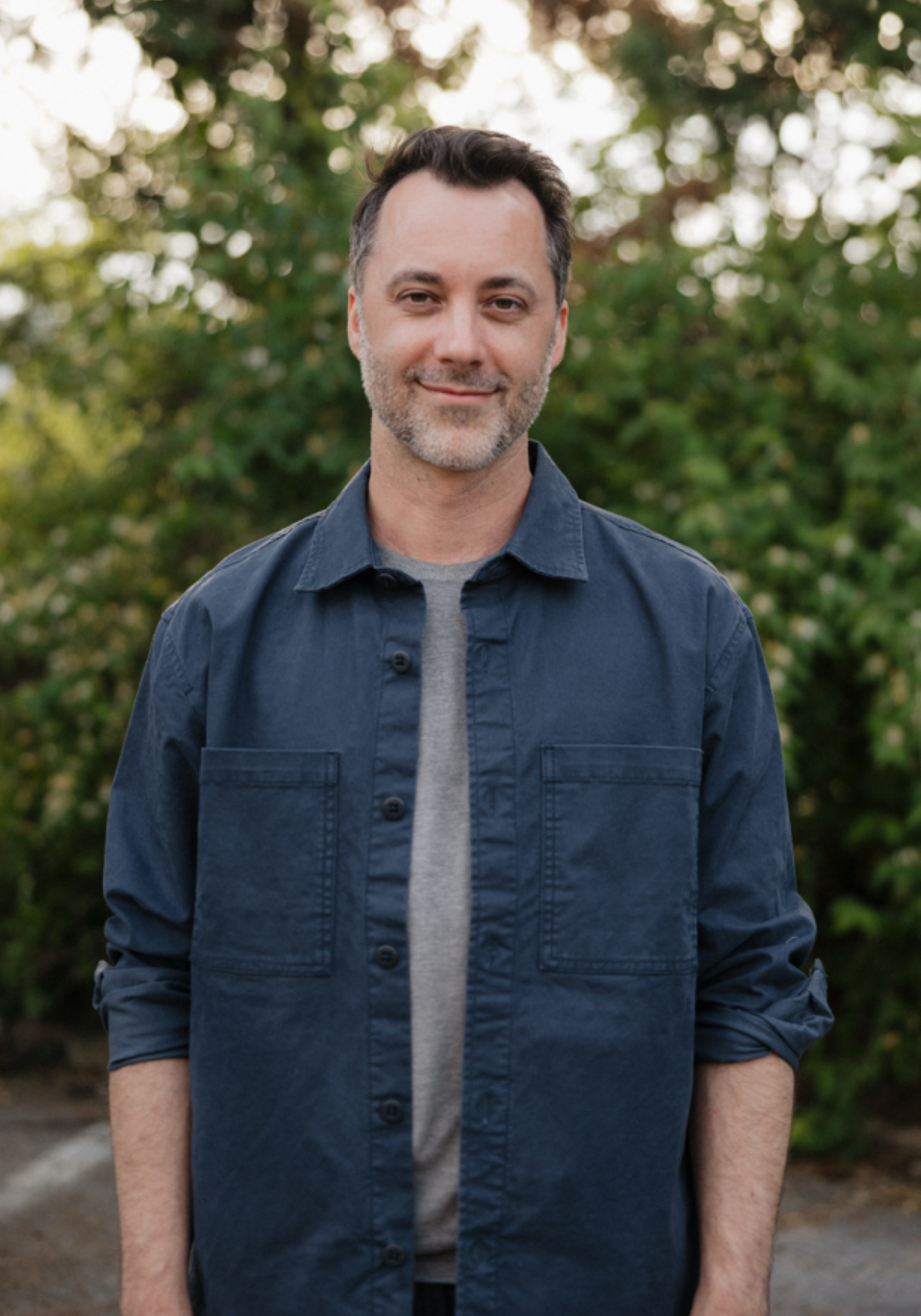 jason-pipkin-a-lpc-mhsp-nashville-therapist Jason Pipkin, A-LPC/MHSP, therapist in Nashville, Tennessee, standing outdoors with a green natural background.